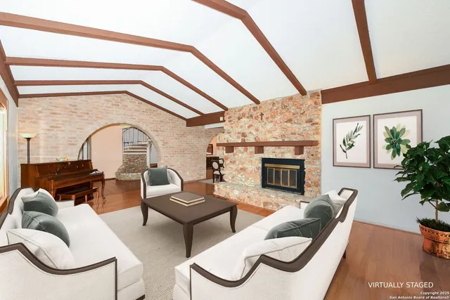 a living room with furniture and a fireplace