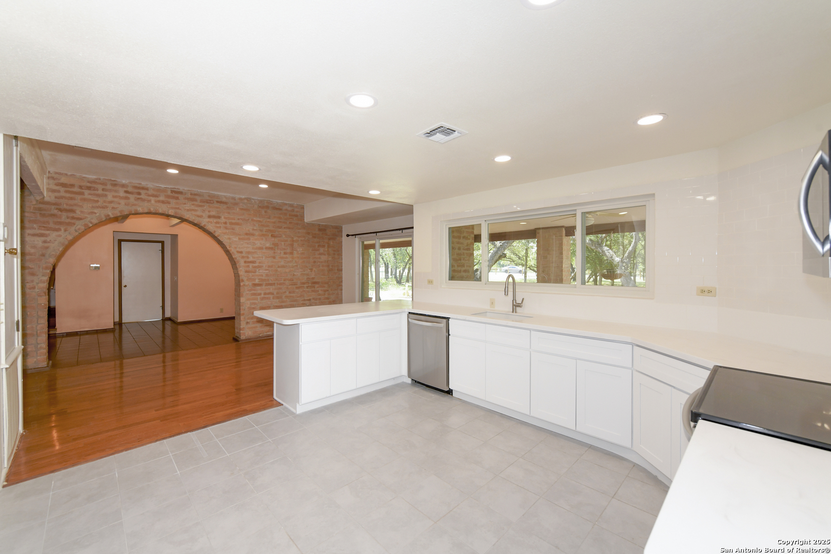 5803 Hollyhock Road San Antonio, TX 78240 - Photo 13 of 51 a large white kitchen with a large window