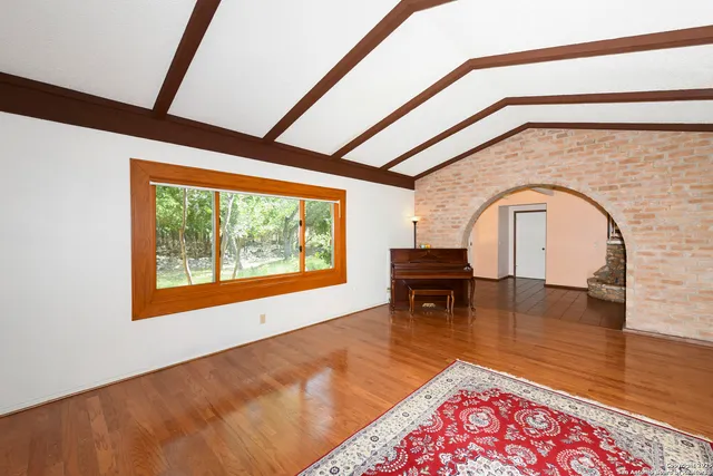 a living room with furniture and a floor to ceiling window