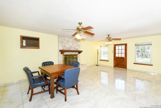 a dining room with furniture and window