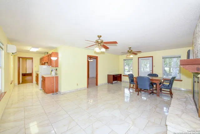 a view of a livingroom with furniture and a window