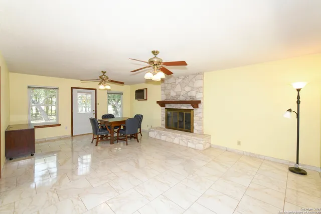 a living room with furniture a fireplace and a table