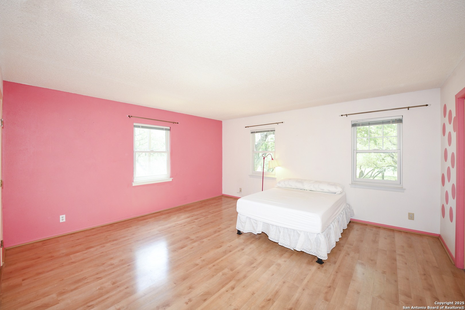 5803 Hollyhock Road San Antonio, TX 78240 - Photo 26 of 51 a spacious bedroom with a bed and a window