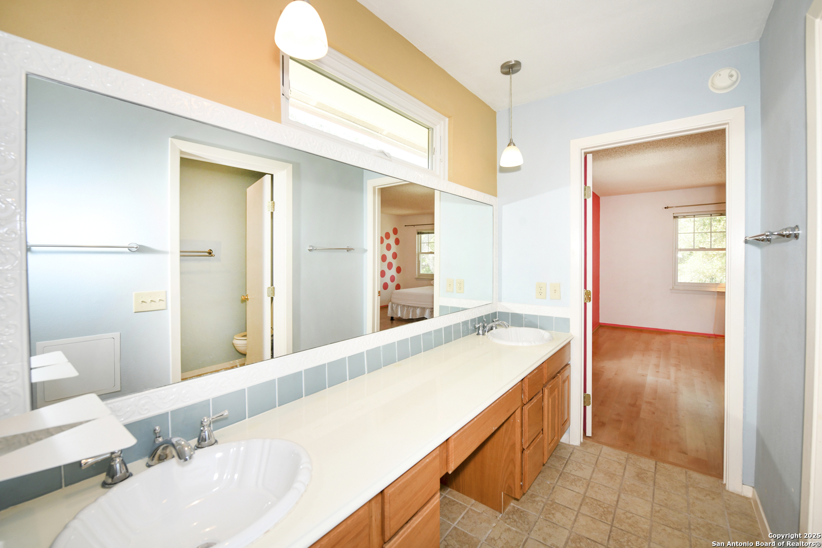 5803 Hollyhock Road San Antonio, TX 78240 - Photo 27 of 51 a spacious bathroom with a granite countertop sink and a mirror