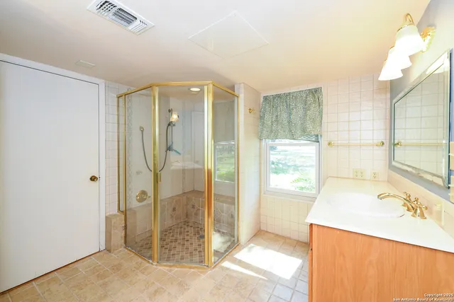 a bathroom with a tub shower and sink