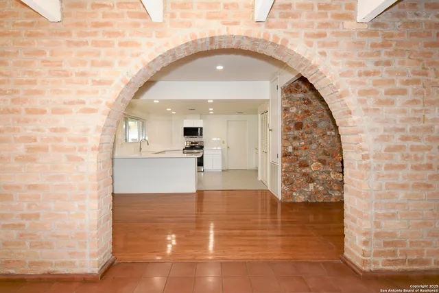 a view of a living room with a fireplace