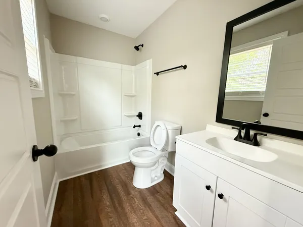 a bathroom with a sink a toilet and a tub