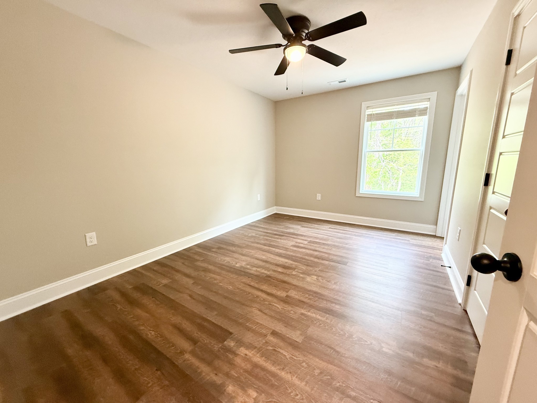 80 Ridge Road, Unit B Waverly, TN 37185 - Photo 10 of 11 a view of a room with wooden floor and a ceiling fan