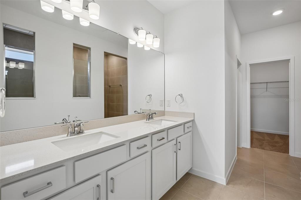 9932 Redwood Rdg Avenue Riverview, FL 33578 - Photo 15 of 38 a bathroom with a granite countertop sink a large mirror and a
