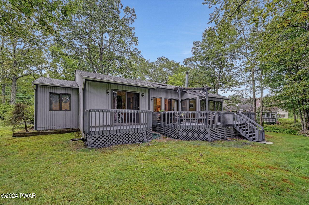 141 Maple Ridge Drive Hawley, PA 18428 - Photo 67 of 84 a front view of a house with a garden