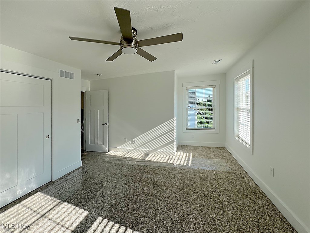 3641 Menlo Road Cleveland, OH 44120 - Photo 11 of 26 Bedroom with carpeting, windows allowing natural lighting, large closet and ceiling fan