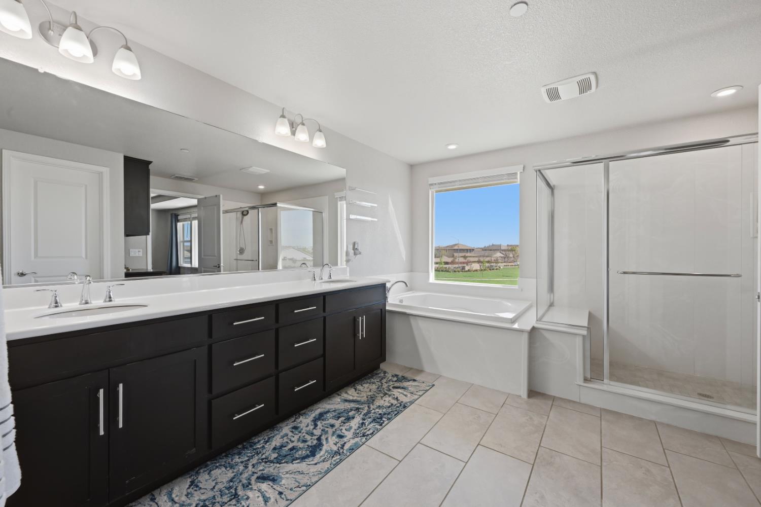 2012 Van Ruiten Drive Lodi, CA 95242 - Photo 31 of 48 a spacious bathroom with a shower sink and mirror