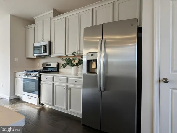 a kitchen with stainless steel appliances cabinets and a refrigerator