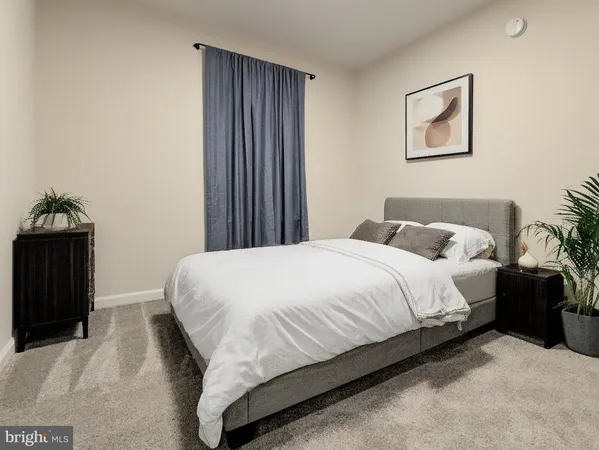 a bedroom with a bed and a painting