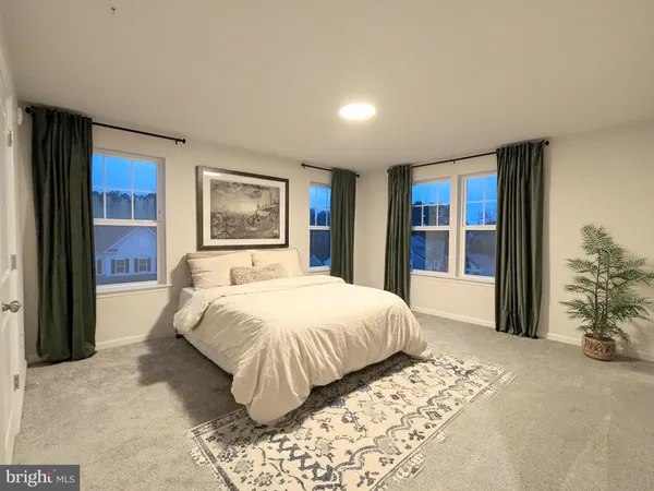 a spacious bedroom with a large bed and a large window
