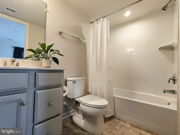 a bathroom with a toilet a sink and bathtub