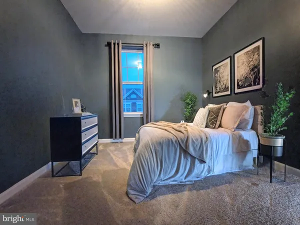 a bedroom with a bed and a potted plant