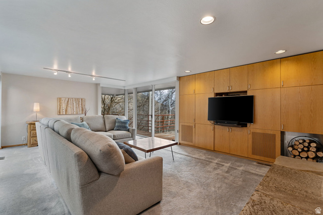 1856 Fort Canyon Road Alpine, UT 84004 - Photo 40 of 49 Living area featuring extensive built-in wood cabinetry, recessed lighting, track lighting, and full-height windows opening to an outdoor railing