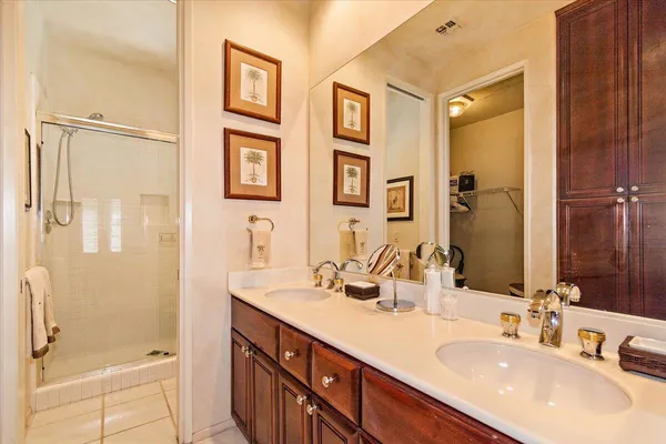 a bathroom with a granite countertop tub shower sink and mirror