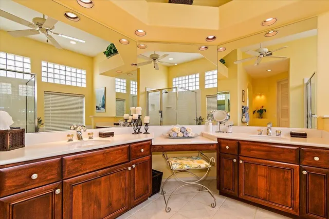 a room with a large window and double vanity