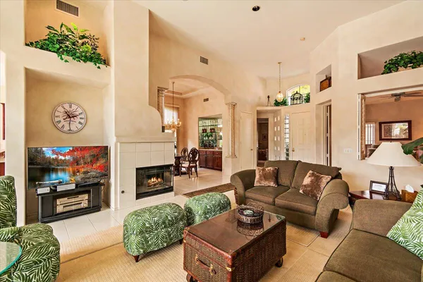 a living room with fireplace furniture and a flat screen tv