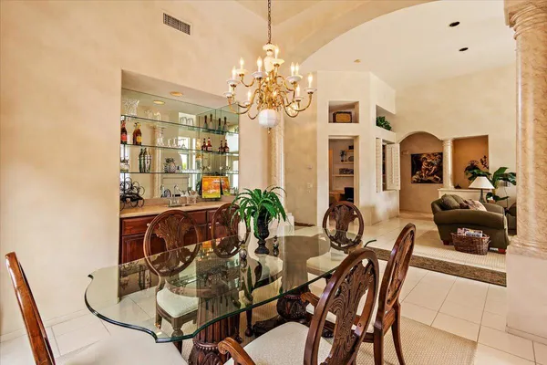 a view of a dining room with furniture and chandelier