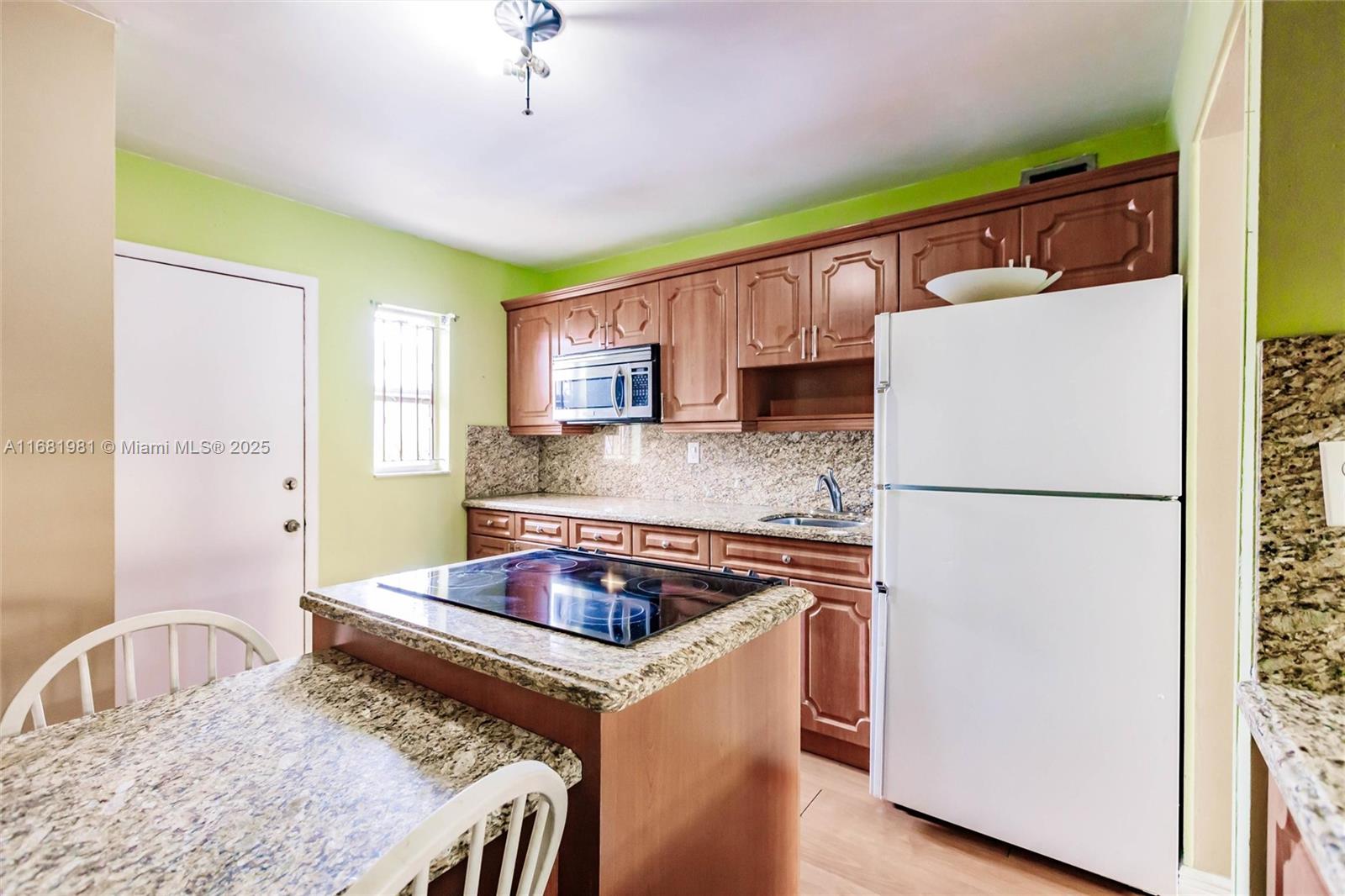 1900 West 54th Street, Unit 213 Hialeah, FL 33012 - Photo 11 of 21 a kitchen with a appliances a sink and a refrigerator