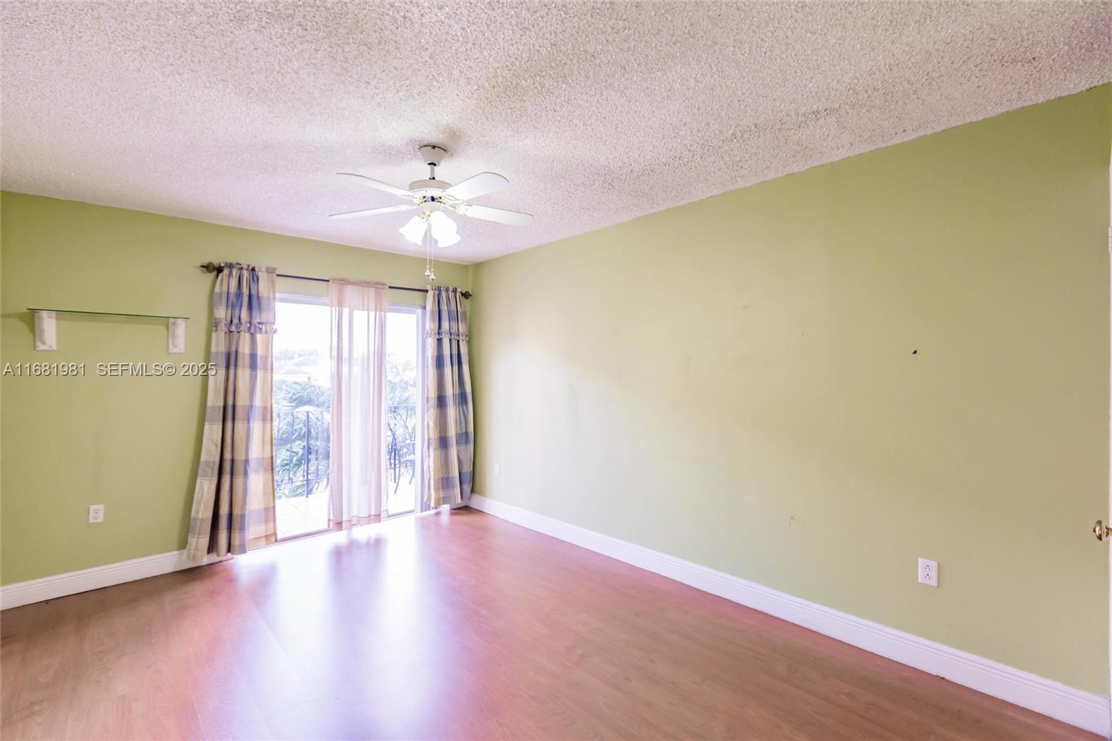 1900 West 54th Street, Unit 213 Hialeah, FL 33012 - Photo 13 of 21 an empty room with windows and ceiling fan