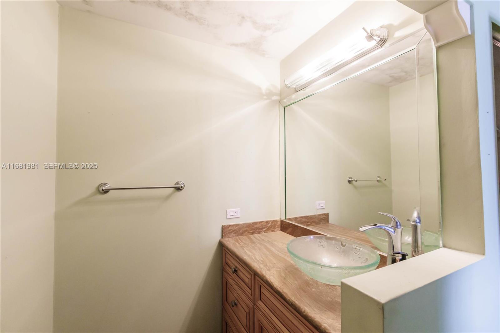 1900 West 54th Street, Unit 213 Hialeah, FL 33012 - Photo 17 of 21 a bathroom with a granite countertop sink and a mirror