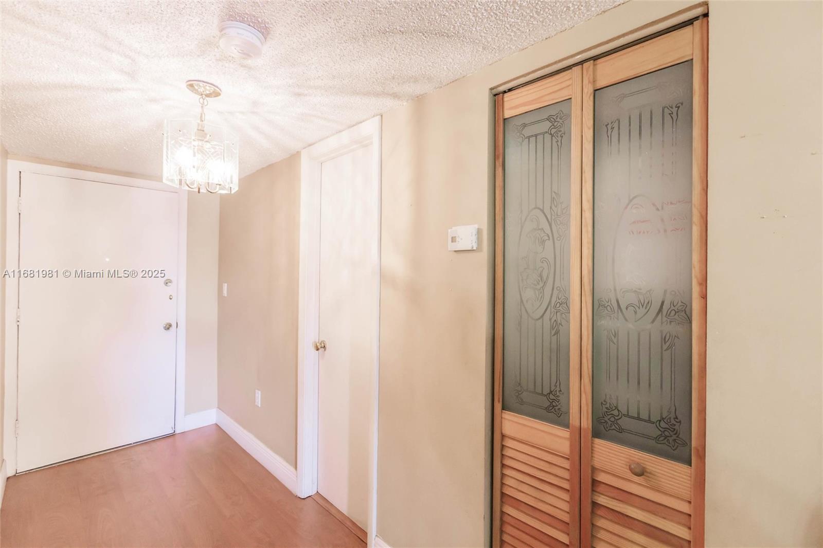 1900 West 54th Street, Unit 213 Hialeah, FL 33012 - Photo 5 of 21 a view of a hallway with shower and wooden floor