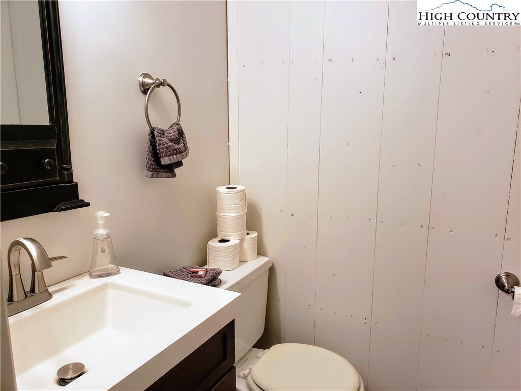 125 Creek Road Boone, NC 28607 - Photo 18 of 32 a bathroom with a sink vanity mirror and toilet