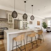 a large kitchen with a table and chairs