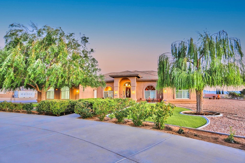23475 El Centro Road Apple Valley, CA 92307 - Photo 1 of 1 a front view of a house with a yard and a garden