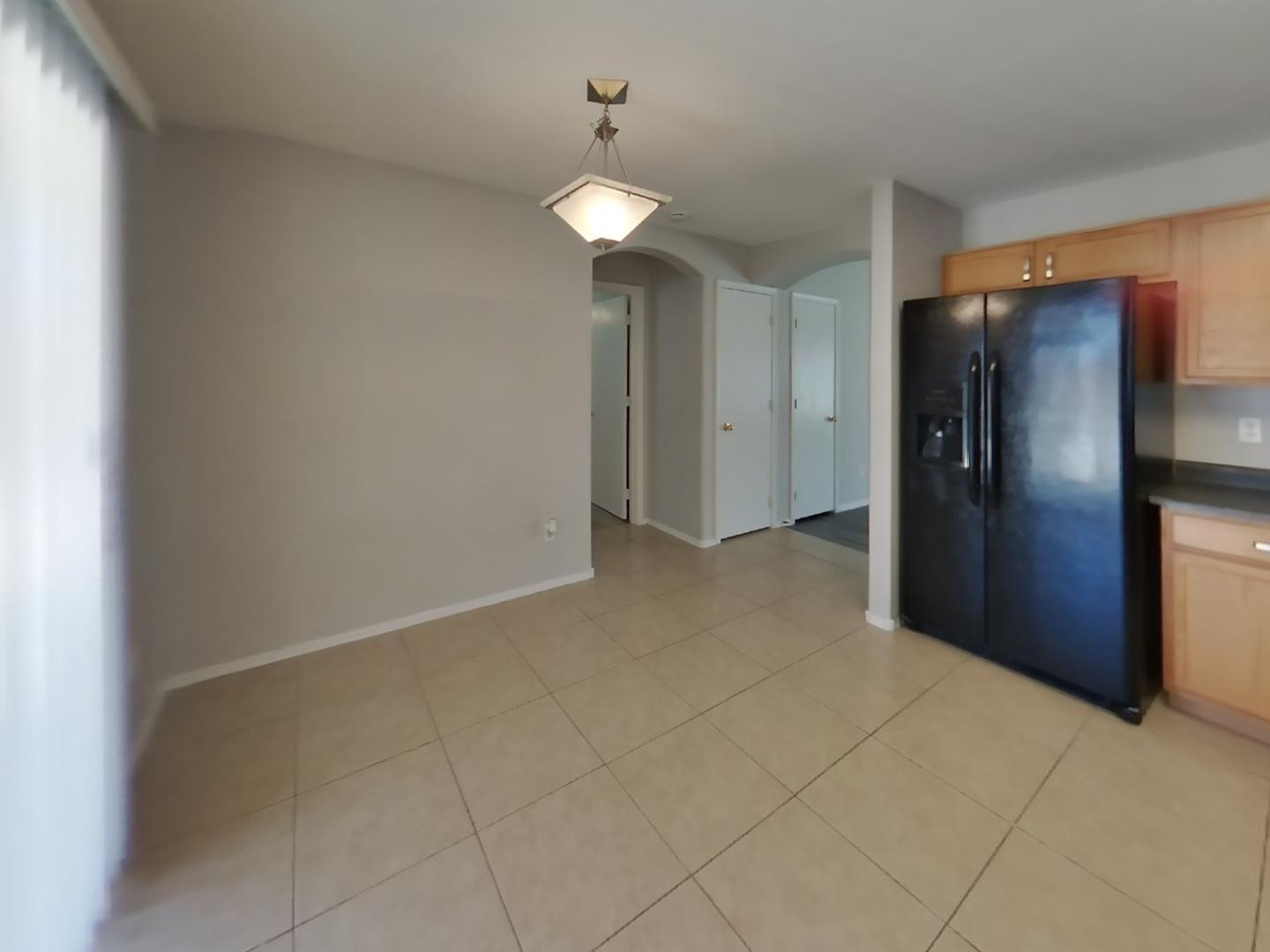 3194 West Tanner Ranch Road San Tan Valley, AZ 85144 - Photo 5 of 15 a view of a kitchen with a refrigerator and a chandelier