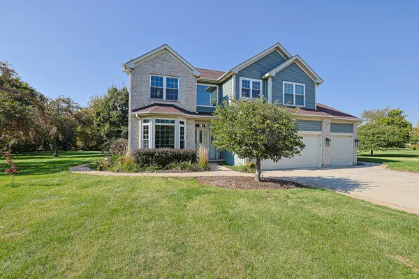 a house that has a big yard and large trees