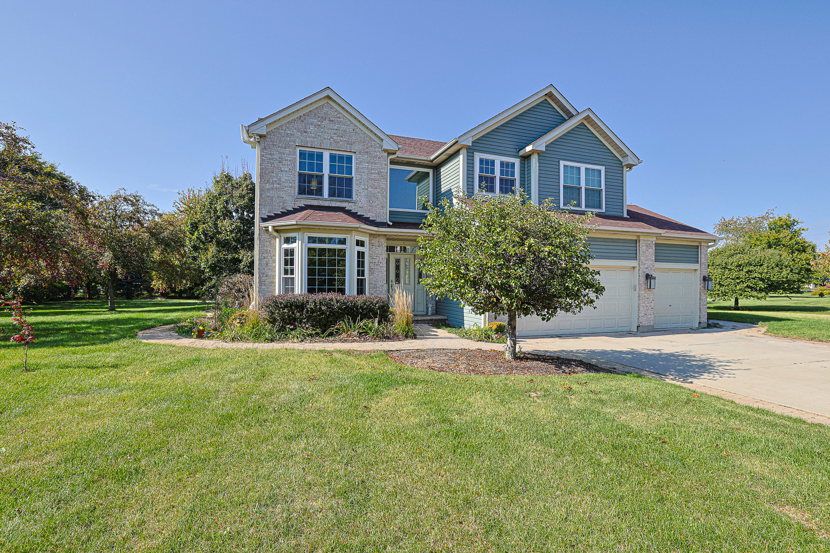 8789 Bentley Lane Spring Grove, IL 60081 - Photo 1 of 1 a house that has a big yard and large trees