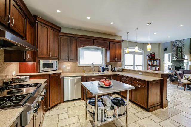 a kitchen with a dining table and chairs