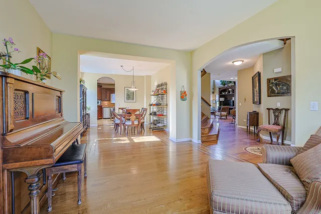 a living room with fireplace furniture and a wooden floor