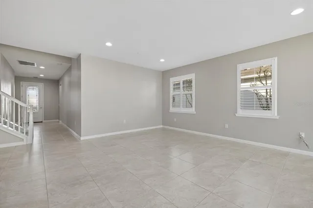 a spacious bathroom with a granite countertop double vanity sink a mirror a shower and a bathtub