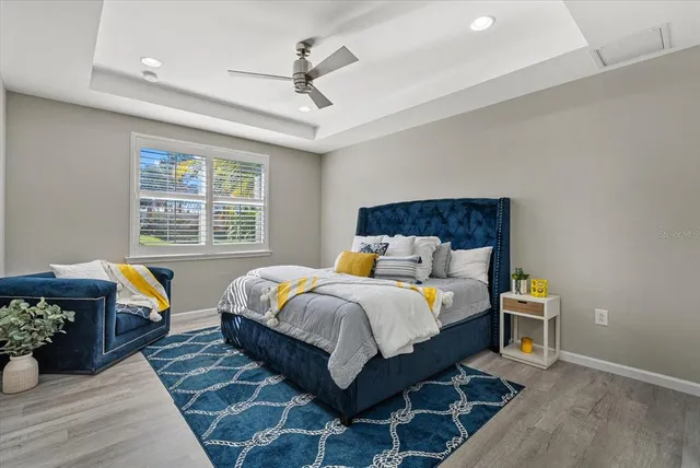 a bedroom with a large bed and a tv