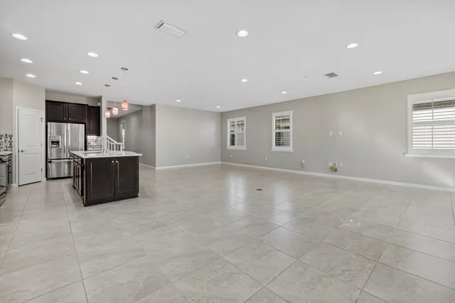 a swimming pool with an outdoor space and seating area