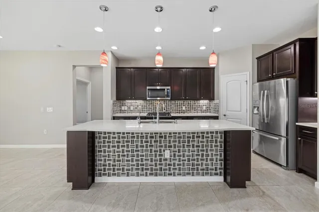 a view of a white house with a yard and plants