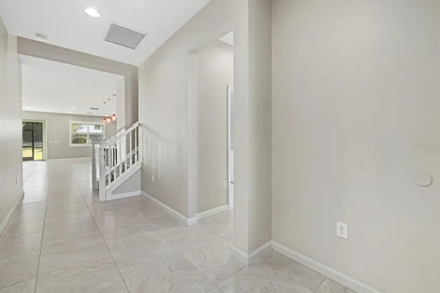 a living room with furniture and a dining table with kitchen view