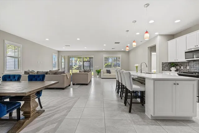 a kitchen with appliances a refrigerator and cabinets