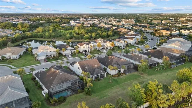 an aerial view of residential houses with outdoor space and swimming pool