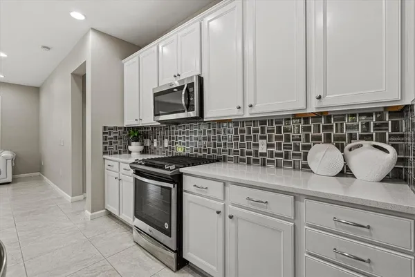 a kitchen with counter space cabinets and appliances