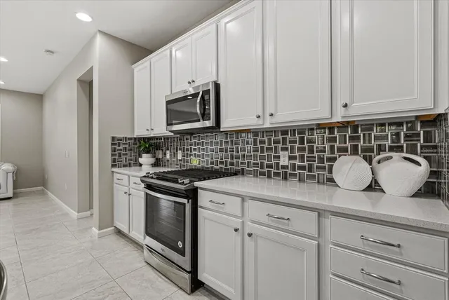 a kitchen with counter space cabinets and appliances
