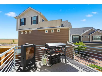 a view of a house with wooden deck outdoor seating