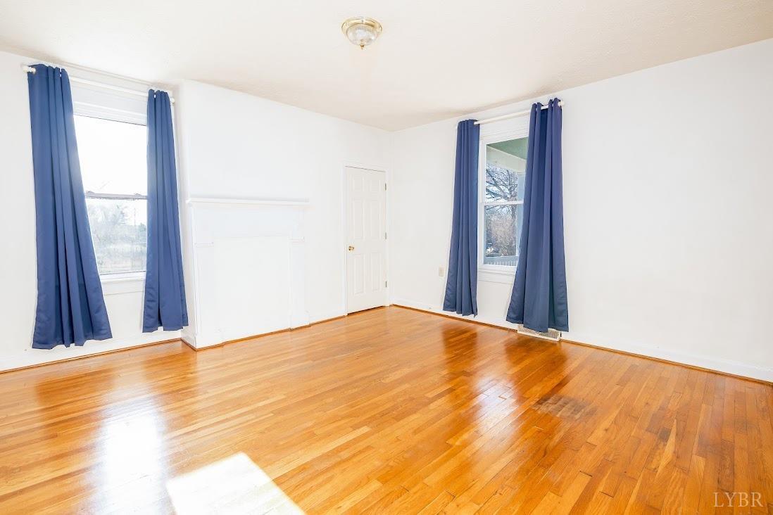 3655 Lowry Road Goode, VA 24556 - Photo 12 of 46 a view of an empty room with wooden floor and a window
