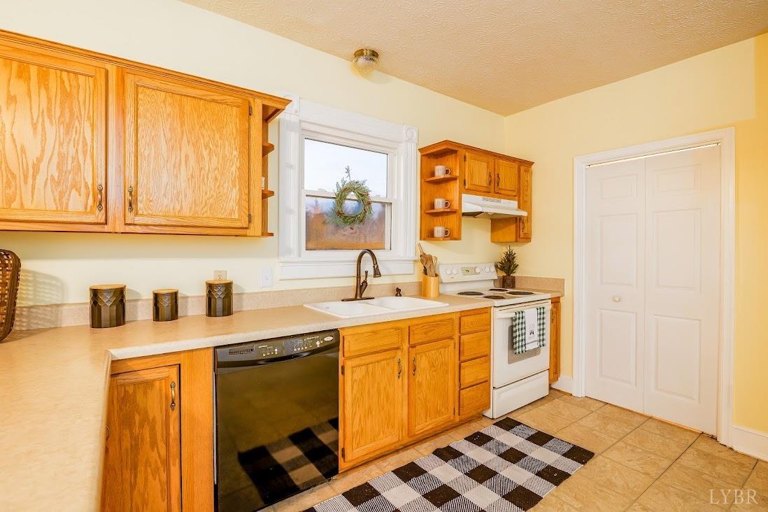 3655 Lowry Road Goode, VA 24556 - Photo 15 of 46 a kitchen with a sink stove and cabinets